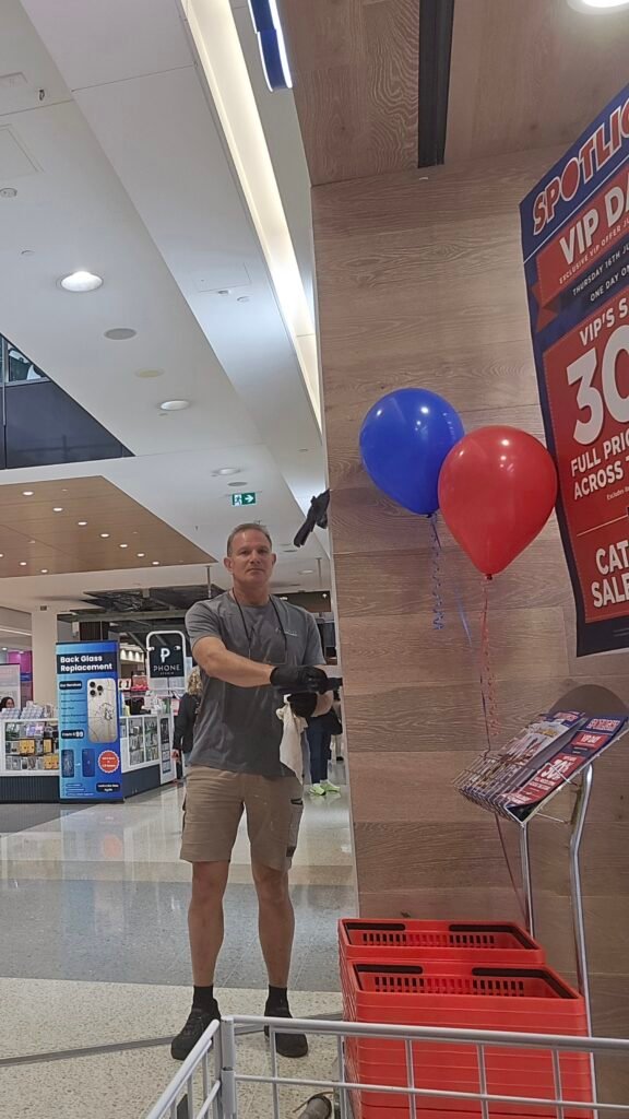 Handyman working on a retail display in a shopping centre