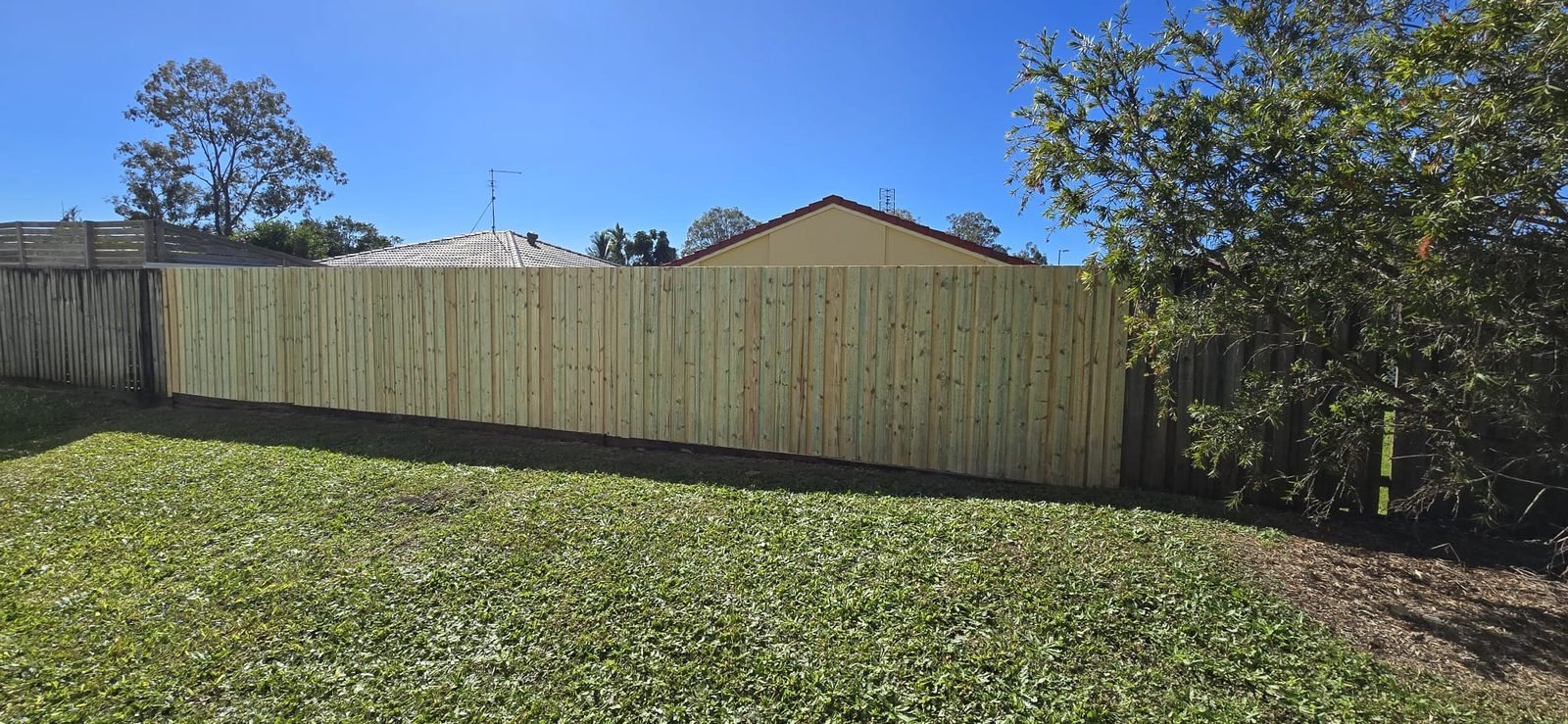 After: straight timber boundary fence by SURVE, Gold Coast