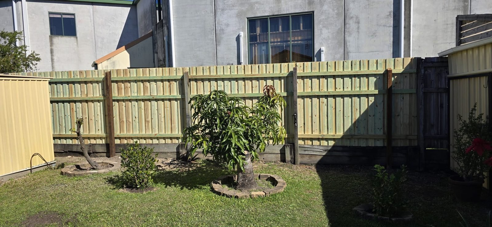 After: timber fence with new posts and palings by SURVE