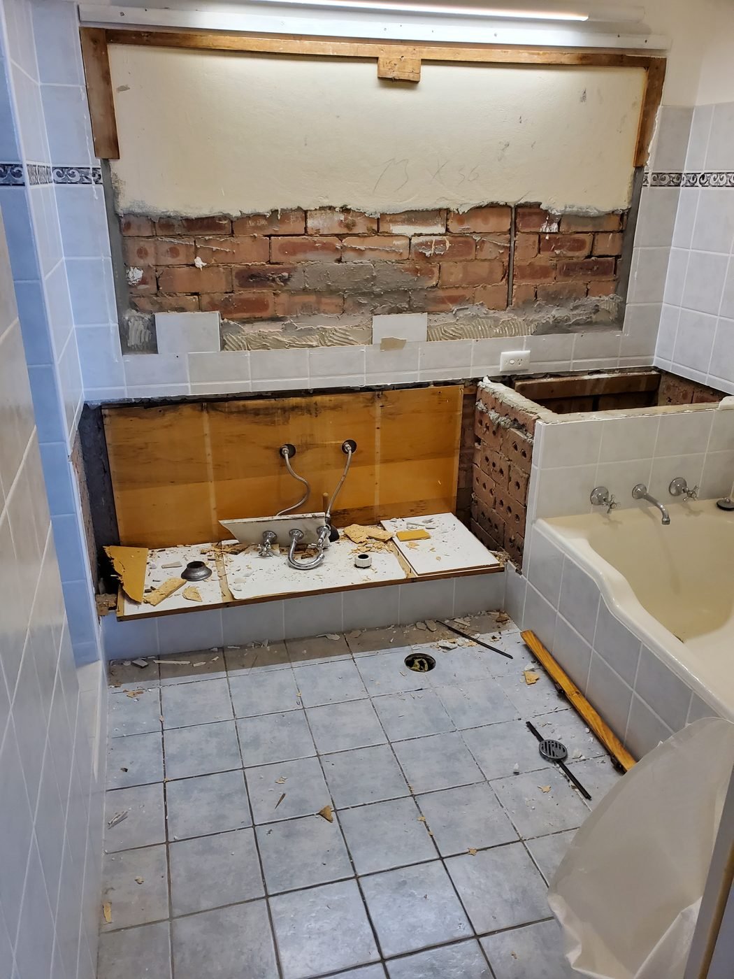 Before: bathroom stripped back to brick