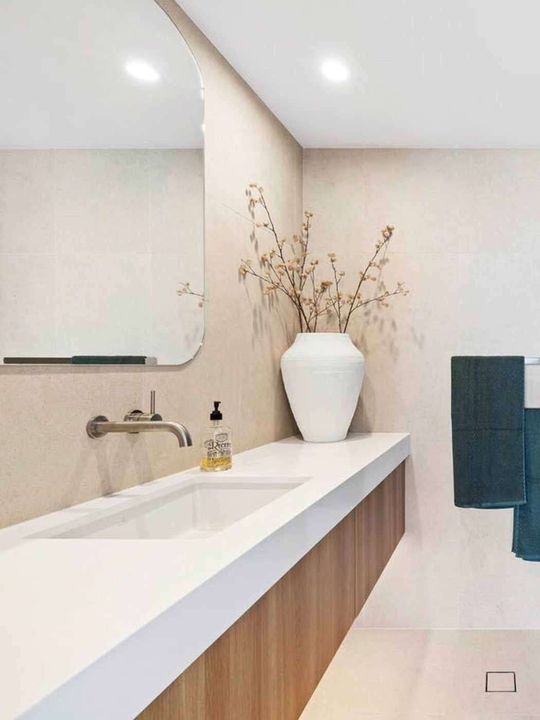 After: floating timber vanity and stone top bathroom renovation by SURVE