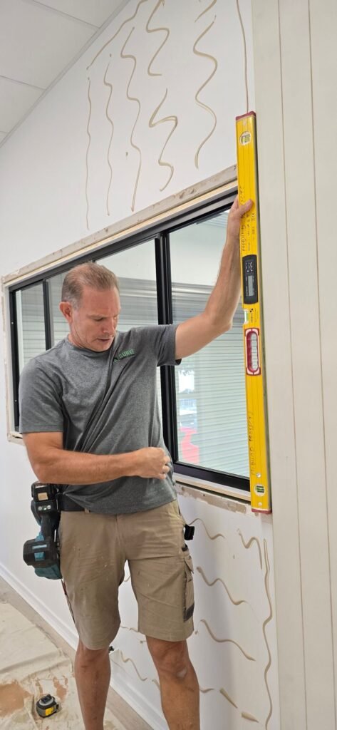 Handyman checking a window frame with a spirit level