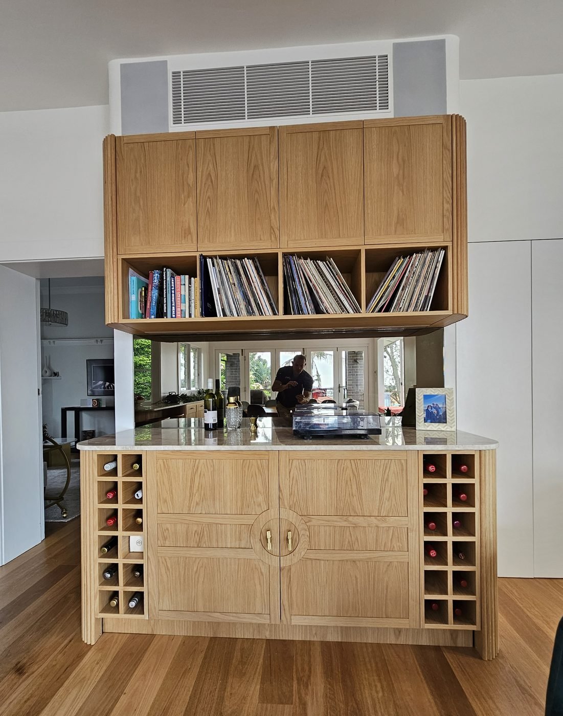 After: custom timber joinery with bar, wine racks and open shelving by SURVE
