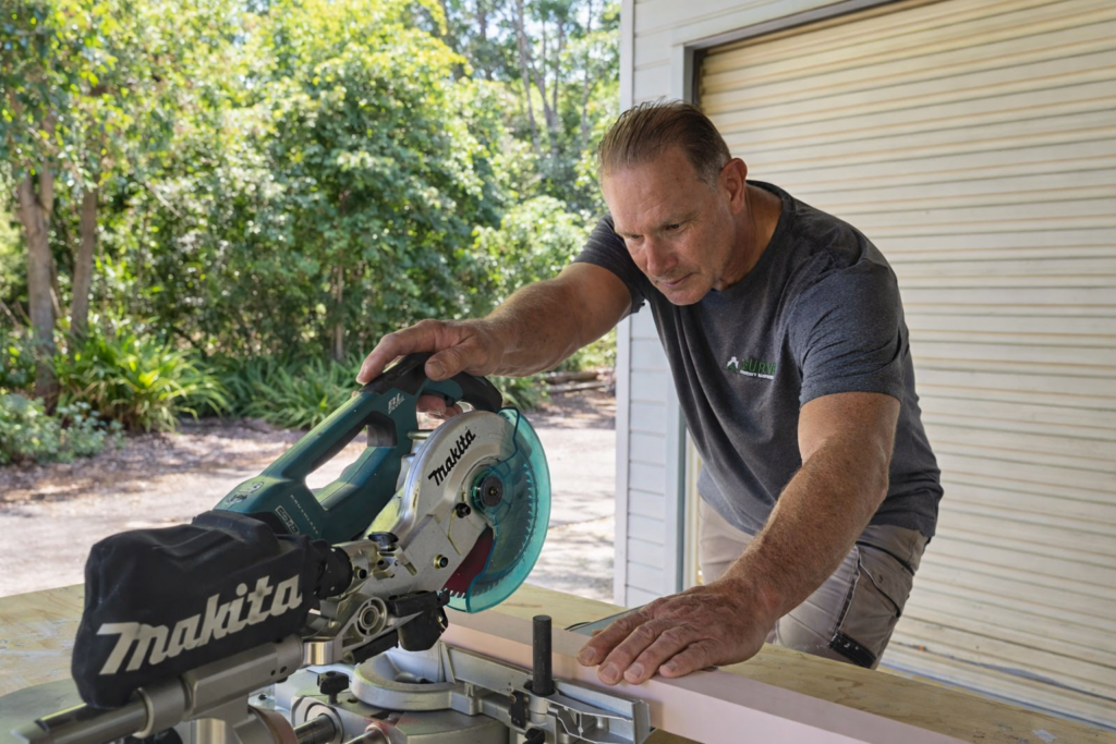 Handyman cutting timber with a mitre saw