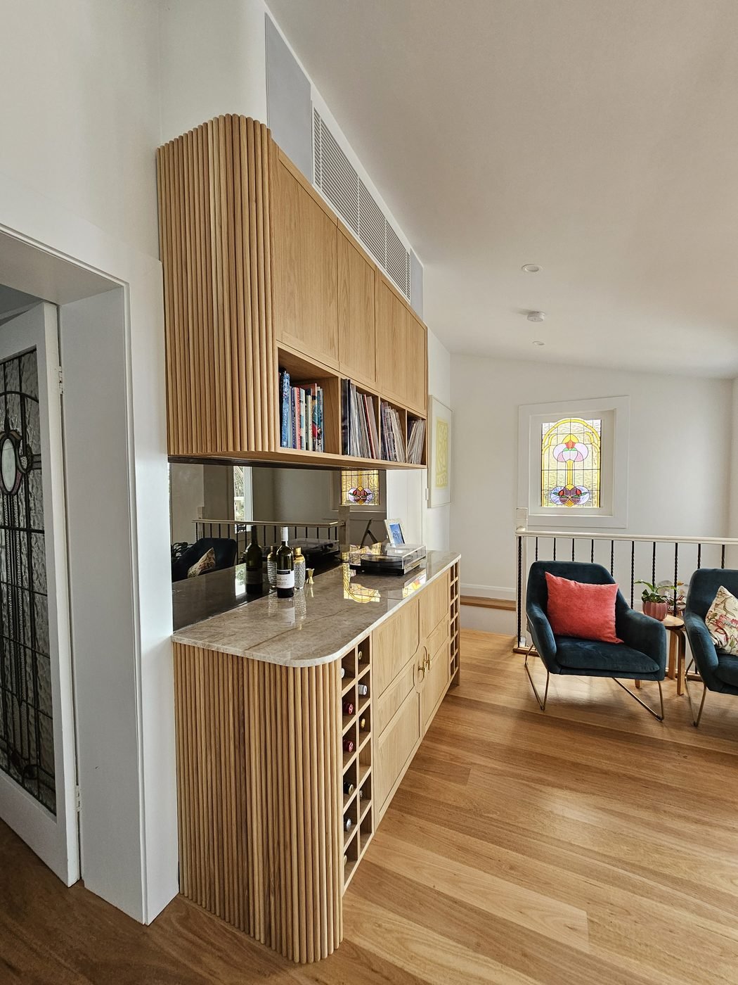 After: hallway with fluted timber joinery and stone benchtop by SURVE