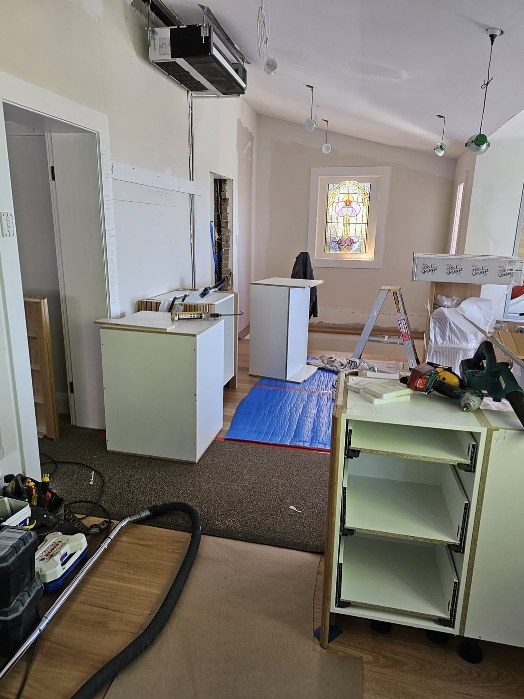 Before: hallway mid-renovation with cabinets being installed